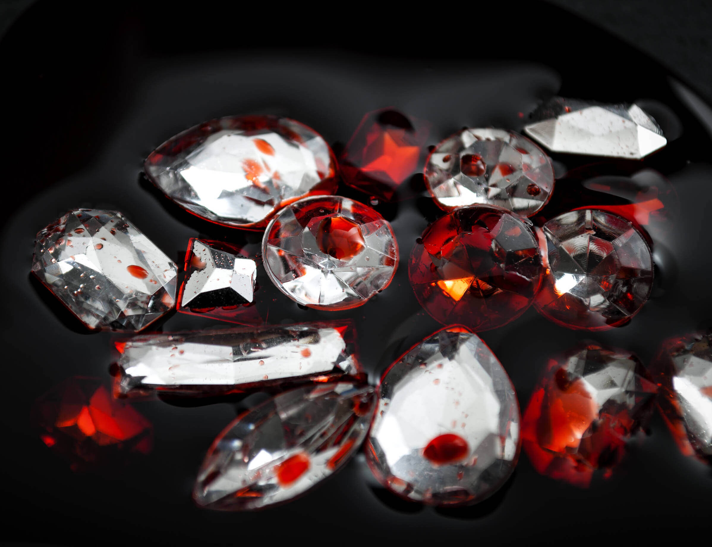 Diamonds covered in blood, with a black background.