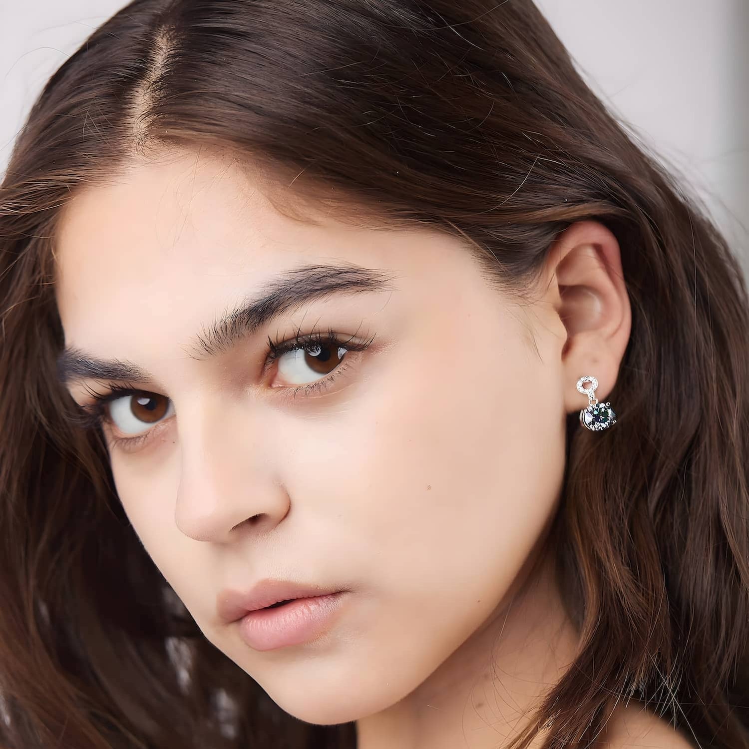 Model wearing the 2 carat moissanite drop earrings in dazzling color