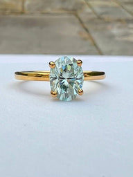 front view of blue green moissanite ring
