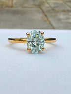 front view of blue green moissanite ring